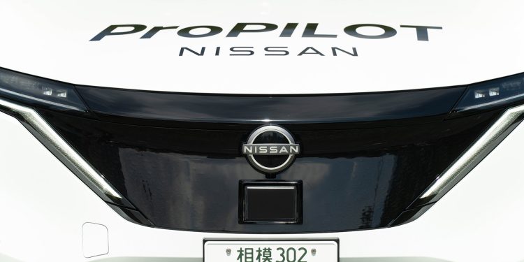 Front of a white Nissan Ariya with a Japanese number plate