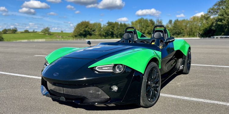 Zenos E10 RZ in green and black under blue skies
