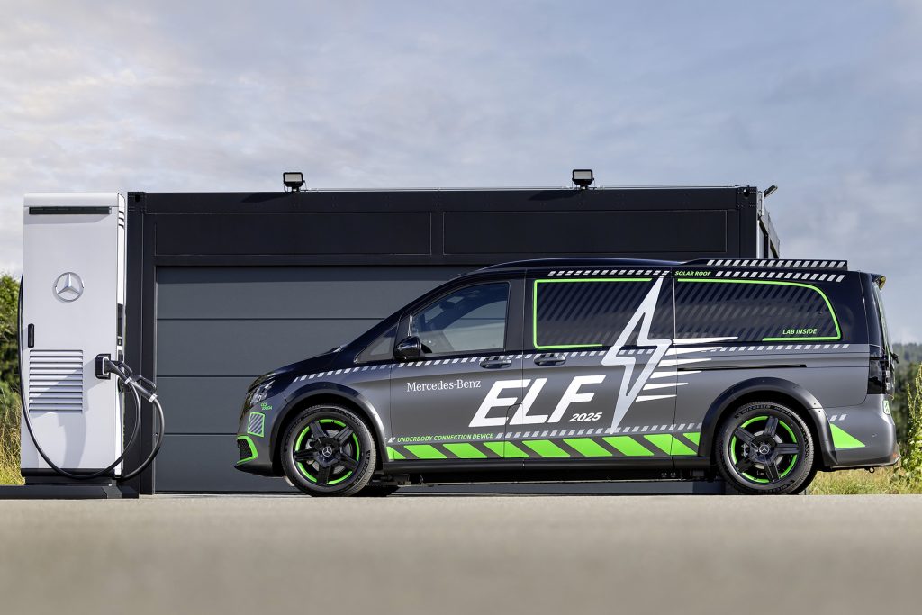 Side profile shot of Mercedes-Benz ELF parked in front of a black garage