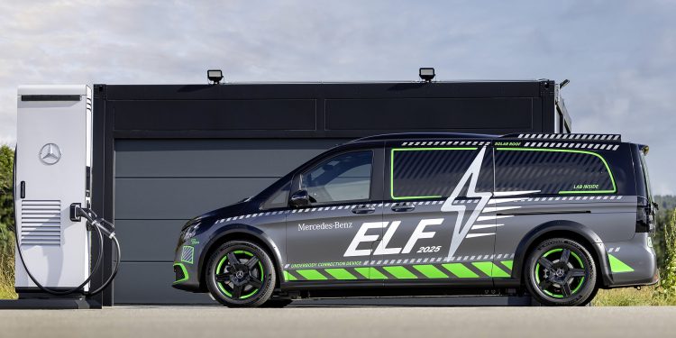 Side profile shot of Mercedes-Benz ELF parked in front of a black garage